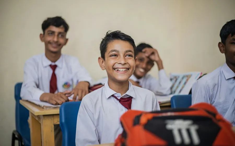 Students in uniform at their desks at the start of a lesson